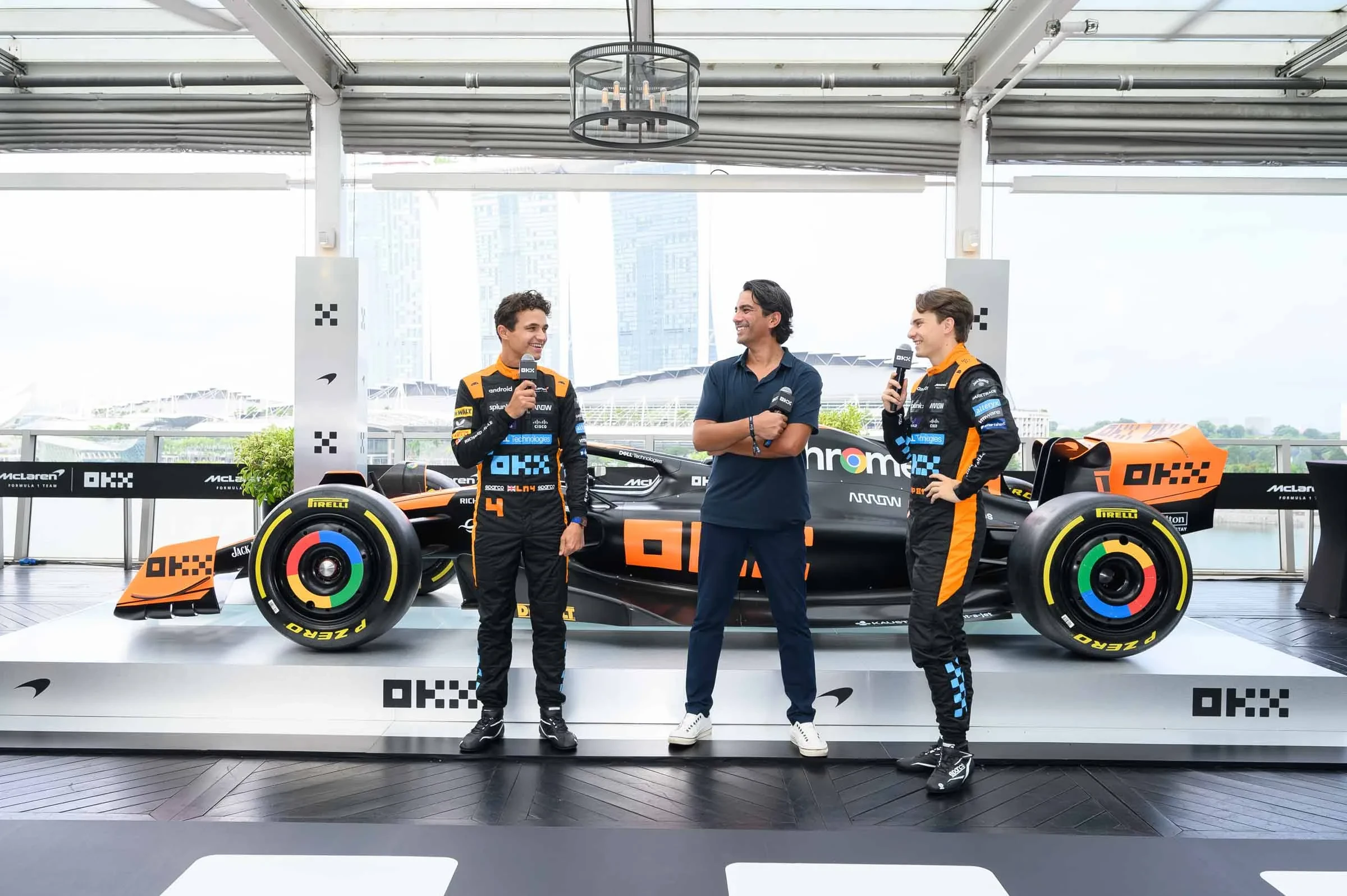 Lando Norris, Haider Rafique and Oscar Piastri revealing the MCL60 in Stealth Mode at an exclusive media event in Singapore at Lantern, Fullerton Bay Hotel