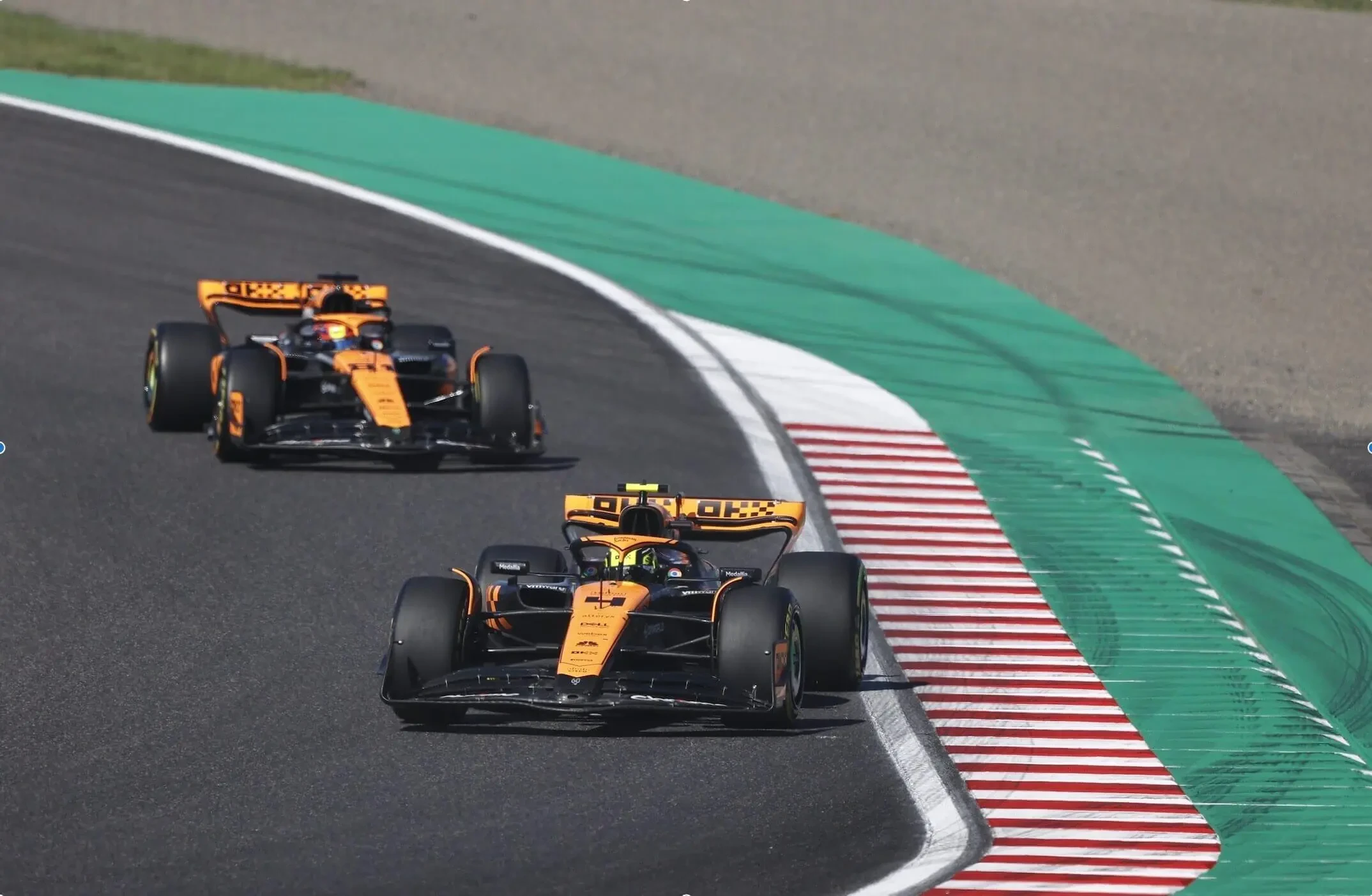 MCL60 race cars in OKX Stealth Mode livery at the Japanese Grand Prix